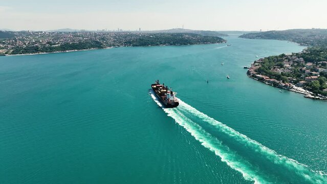 Aerial top view Container ship full load container on the green sea with beautiful wave pattern for logistics 