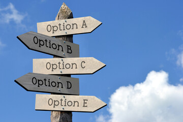 Option A, B, C, D, E - wooden signpost with five arrows, sky with clouds