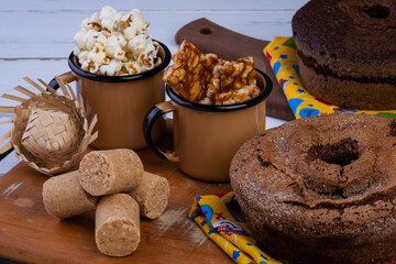 wooden tray with cake, popcorn and sweets from festa junina