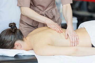 Obraz na płótnie Canvas Professional massage therapist giving back massage for natural pretty woman. Natural beauty massage spa self care shot