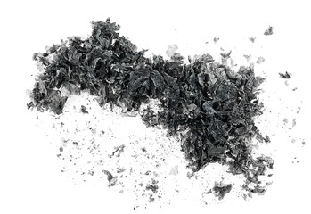 Pieces of burnt paper on a white background, top view. Charred paper scraps. The ashes of the paper.