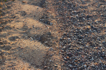 close up of a gravel countryside road with sunset light