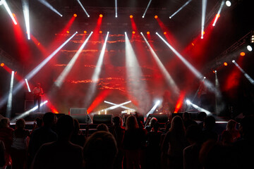 Colourful concert arena with a crowd silhouette against stage lights. silhouettes of the audience against the background of the concert stage