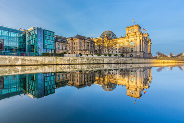 Fototapeta na wymiar Reichstag with reflection in river Spree