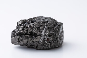 Natural black fossil coal on a white isolated background.