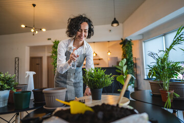 woman gardener florist take care grow cultivate plants at home