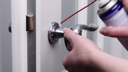 lubrication of door locks. adjustment of door handles with lubricating oil. in room. fixing a door creak is a household problem.