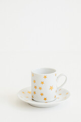 white espresso, Turkish coffee cup with gold stars on white background