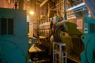 Ship's engine room. Vessel's ( Ship ) Engine Room Space / industrial stairs. Ship's Engine Heavy Machinery Space - Pipes, Valves, Engines