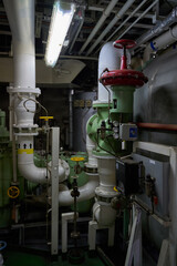 Ship's engine room. Vessel's ( Ship ) Engine Room Space / industrial stairs. Ship's Engine Heavy Machinery Space - Pipes, Valves, Engines