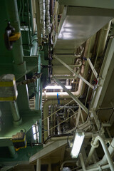 Ship's engine room. Vessel's ( Ship ) Engine Room Space / industrial stairs. Ship's Engine Heavy Machinery Space - Pipes, Valves, Engines