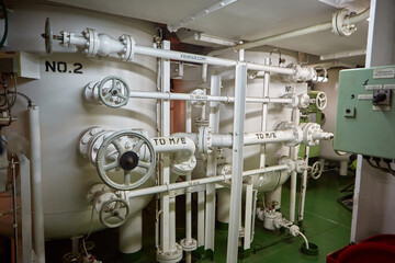 Ship's engine room. Vessel's ( Ship ) Engine Room Space / industrial stairs. Ship's Engine Heavy Machinery Space - Pipes, Valves, Engines