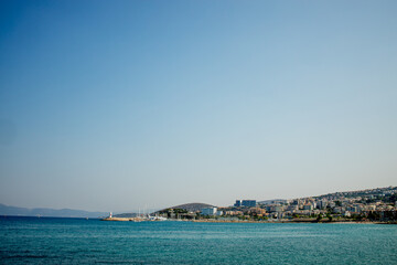 A view of a populated Turkish city on the seashore. Mountain horizon of the seashore