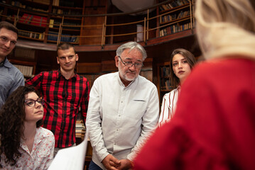 The senior professor gives a lecture to the students at the University library