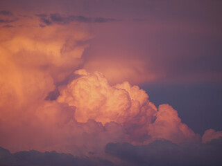 CLOSE UP: Dramatic clouds colored in vibrant pink and blue shades after sunset