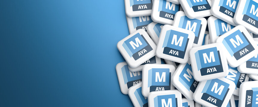 Logos of the 3d modeling, animation and rendering software Maya by Autodesk on a heap on a table.