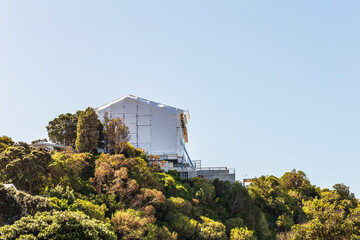 Large plastic-wrapped house on the hill