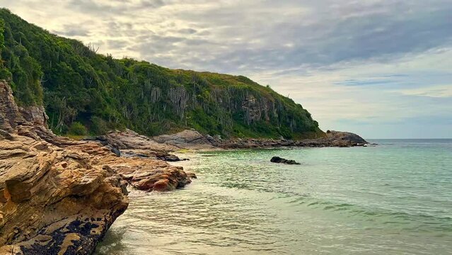Praia da Concha, reveals the timelapse Beautiful sunny day, coastal vegetation, mountains, waves hitting the rocks. Stunning blue sea water. The most popular white sand beach in Rio de Janeiro.