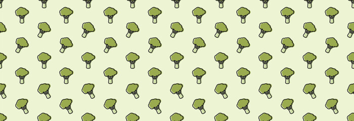 A lot of broccoli on a light background, seamless background.