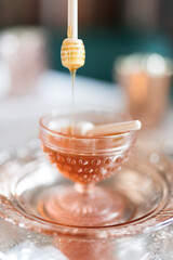 honey dripping from a wooden spoon