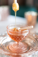 honey dripping from a spoon at a tea party