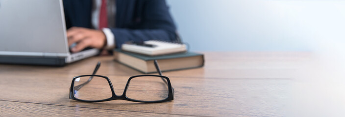 man using laptop computer with eyeglasses