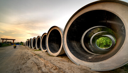 Asian woman in red shirt practicing yoga on the background of concrete pipes Ho Chi Minh City, Vietnam
