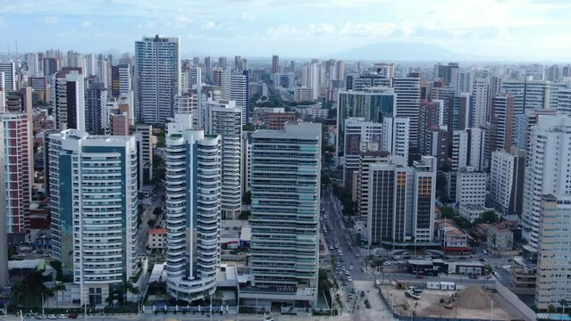 Beira Mar de Fortaleza. Fortaleza city,  Brazil. Flying towards beach with Hotels and Resorts Backdrop beach drone footage. Skyline of Fortaleza city from ocean, Ceara State, Brazil