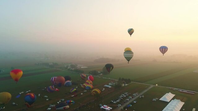 Aerial View of an Early Misty Morning of Hot Air Balloons Rising into the Fog