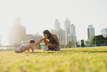 "Candid Family Moment: Baby Crawls Toward Mom in the Park"

