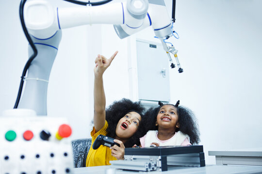 Kid-friendly experiments to education learning technology science robotics mechanics classes intelligent smart,Robotic Arm with remote control while testing his engineering wonder.