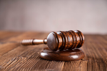 Law and justice concept. War crimes. Gavel, scale and Themis sculpture in lawyers office. Gray...