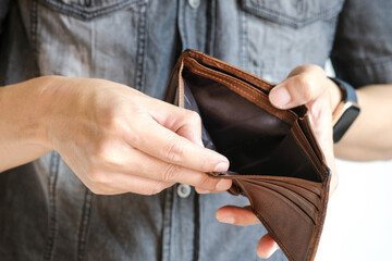 Man's hand open the bag No money in the pocket, financial problems Finance and expenses concept,