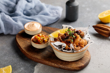 Crispy Prawns and Calimari with dip and lime served in dish isolated on table top view of arabic breakfast
