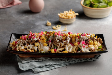 Chicken Shawarma Nachos served in dish isolated on table top view of arabic breakfast