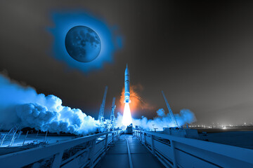 The Start of a Night Rocket Launch: Blue Smoke Surrounds the Rocket in the Moonlight - obrazy, fototapety, plakaty