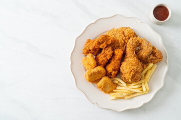 fried chicken with french fries and nuggets on plate