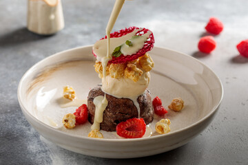 Chocolate Fondant with raspberry served in dish isolated on table top view of arabic breakfast