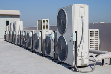 Air conditioning (HVAC) installed on the roof of industrial buildings.	