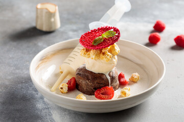 Chocolate Fondant with raspberry served in dish isolated on table top view of arabic breakfast