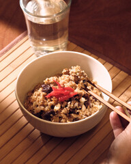 Japanese bowl of rice with a glass of water