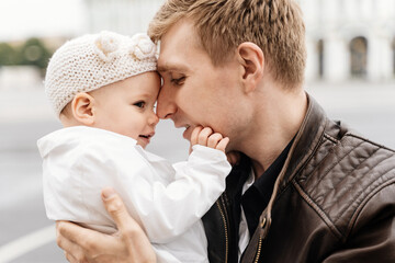 Fototapeta premium A man with a toddler daughter hugging on Palace Square St.Petersburg