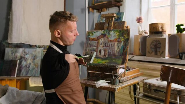 Portrait of a male artist with disabilities painting a picture