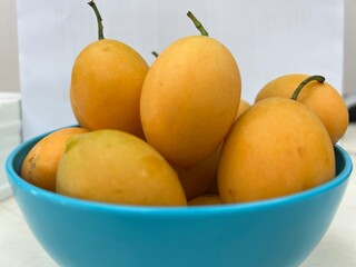 Ripe yellow mango, sweet and sour tropical fruit, yellow mango, same family as mango.