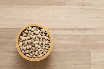 Top view of Black eyed beans in a bowl on wooder background, Healthy eating concept