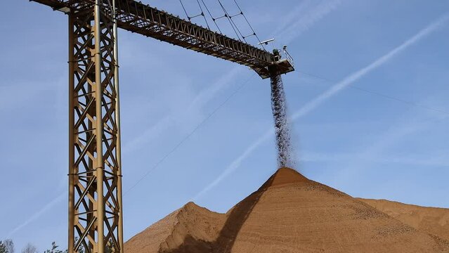 crane of a conveyor belt mining sand in an industrial plant