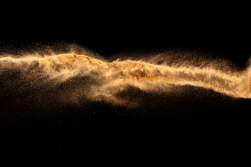 Fototapeta na wymiar Brown colored sand splash.Dry river sand explosion isolated on black background.