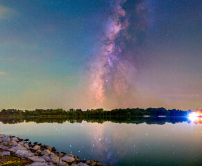 Scenic view of forest and galaxy reflection in lake at night