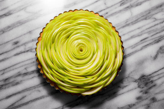 Overhead view of rose apple pie on marble counter