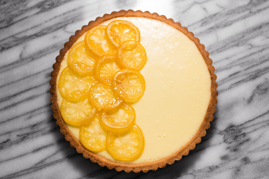 Overhead view of lemon tart on marble counter